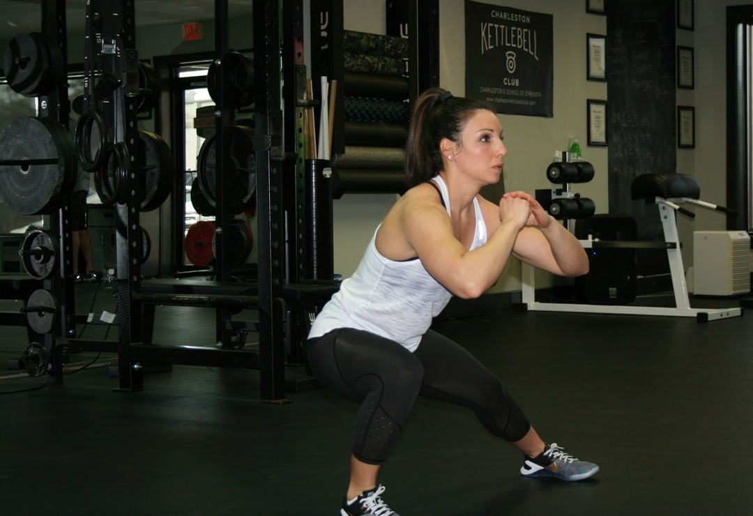 A member sinks into a deep lateral lunge.