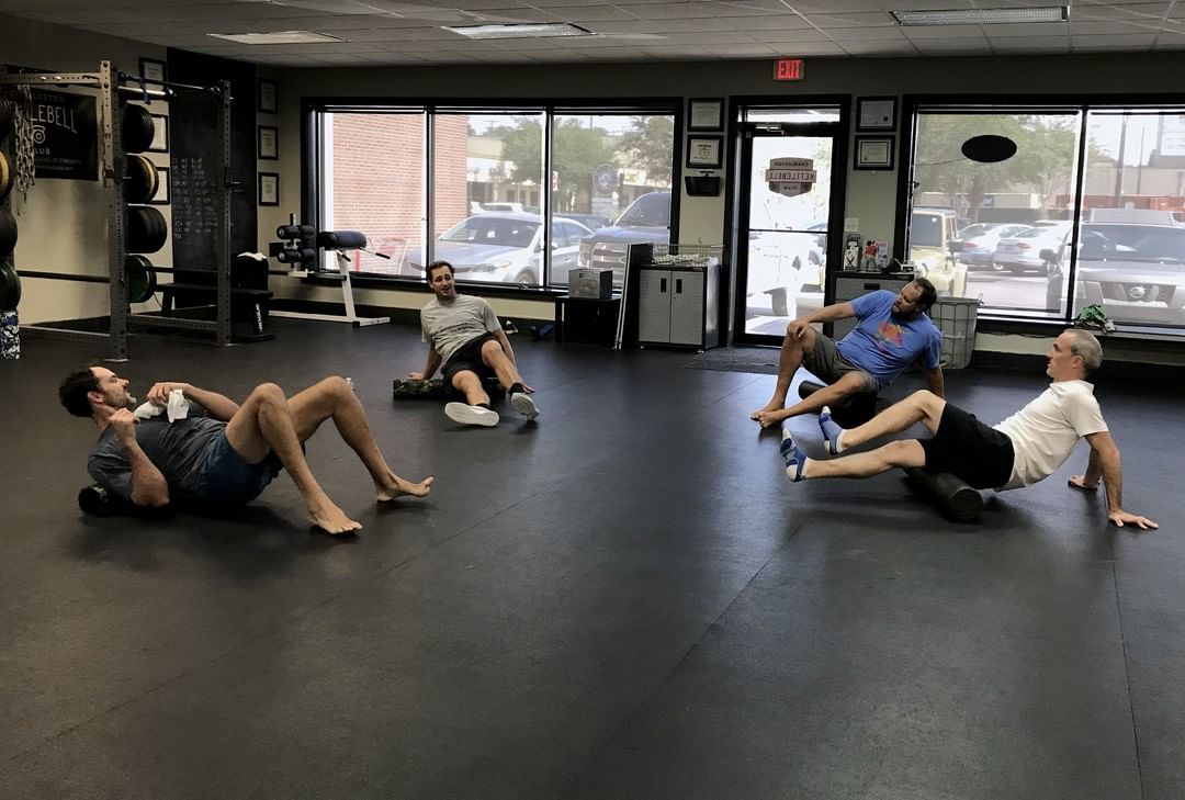 Members work through a mobility drill on the floor.