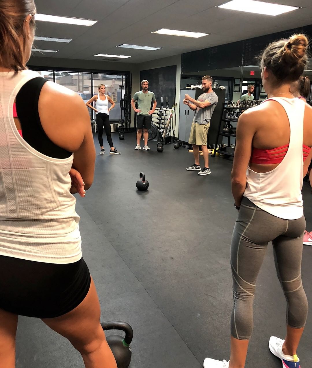 Members gather on the gym floor for a group class.